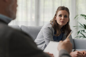 therapist helping young woman in understanding the stages of addiction