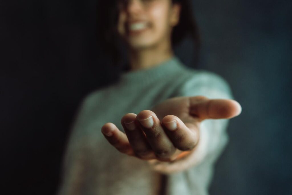 image of woman extending hand in aid as a metaphor for treating the signs of meth abuse