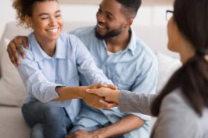 father and daughter meeting with therapist to discover the 5 benefits of family counseling