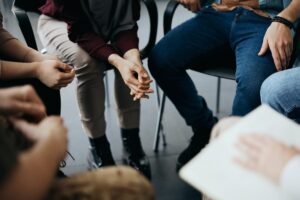 therapist explaining to group of men and women the advantages of finding outpatient treatment in North Carolina