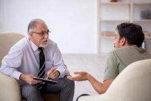 addiction treatment specialst explaining to confused client about recognizing co-occurring conditions.