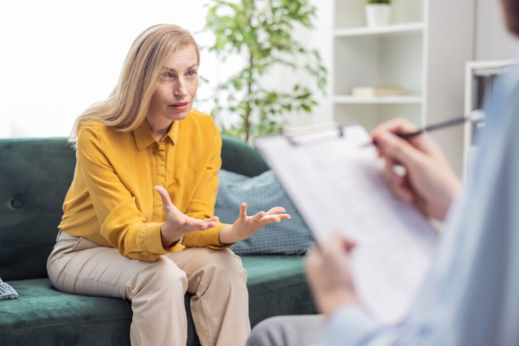 behavioral health specialist explaining to female client how ACT for addiction recovery can help maintain sobriety.