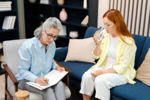 young woman participating in an all-female therapy session after finding gender-specific addiction treatment in NC