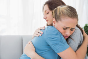 Two family members hugging during an intervention aimed at helping a loved one with meth addiction