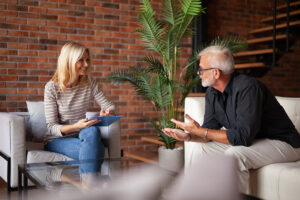 behavioral health therapist meeting with young woman in office setting and discussing the advantages of outpatient rehab