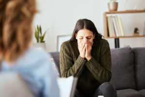 addiction specialist talking with distraught client in office setting about why ACT is effective for addiction treatment.