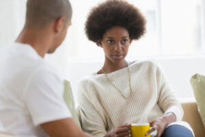 A man wondering, "How do I get my wife to stop drinking?"