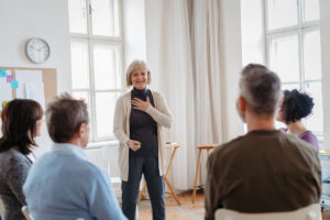 Woman standing up in group therapy session