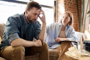 worried man sitting with concerned woman